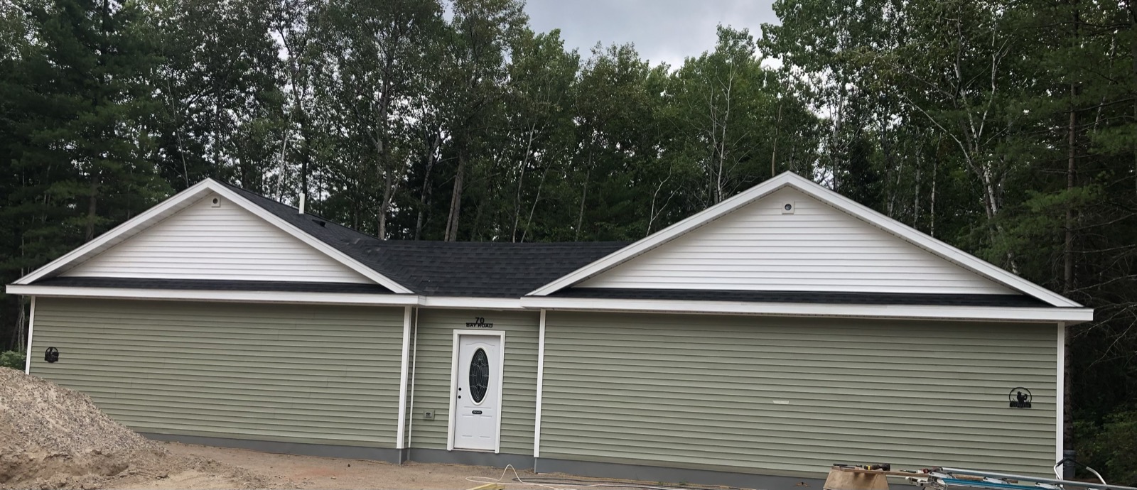 Exterior of Northwoods Escape, showing both villas under one roof, mid-construction